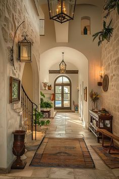 an entry way leading into a home with stone walls and arched doorways on both sides