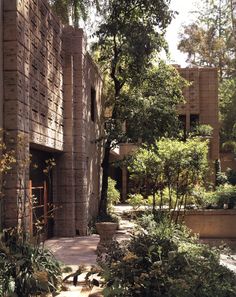 the building is made out of bricks and has many trees