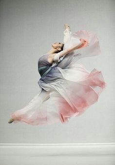 a woman in a dress is flying through the air