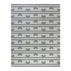 a gray and white rug with small grey crosses on it