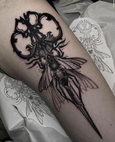 a black and white photo of a tattoo on the leg