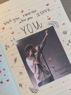 a notebook with an image of a boy holding a microphone and the words you are my love written on it