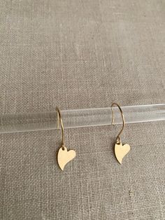 "Round hoop like ear wire with a gorgeous heart drop. Measure 1 ⅜\" All made of worry free 14Kt Goldfilled materials made in USA 🇺🇸  Will not irritate sensitive piercing  Will not change color or rub off" Minimalist Heart Jewelry With Ear Wire, Minimalist Gold Heart Earrings With Charm, Minimalist Gold Hypoallergenic Heart Earrings, Minimalist Dangle Hoop Earrings For Valentine's Day, Dainty Heart-shaped Hoop Earrings For Everyday, Dainty Teardrop Heart Earrings For Gift, Everyday Heart-shaped Drop Earrings, Dainty 14k Gold-filled Earrings With Heart Charm, Everyday Heart Drop Earrings