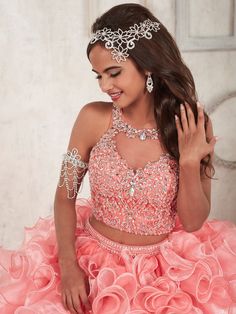 Be a trendsetter in this beaded long two piece crop top dress with ruffled A-line skirt by House of Wu Quinceanera Collection 26830. Saturated in chunky, AB rhinestones, this two-piece presents a bodice with an enchanting illusion neckline and beaded straps. The back of the bodice has brilliant rhinestone buttons and loops. The two-tone skirt fans out in cascading metallic organza ruffles with wire edging. House of Wu Quinceanera Collection Fall 2016 Style Number: 26830 Fabric: Organza Colors: C Two Piece Quinceanera Dresses, Prom Gown Elegant, Cheap Quinceanera Dresses, Quinceanera Collection, Sweet 15 Dresses, Quinceñera Dresses, Two Piece Gown, Quinceanera Dress, Pink Prom