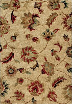 a beige rug with red and green flowers on it