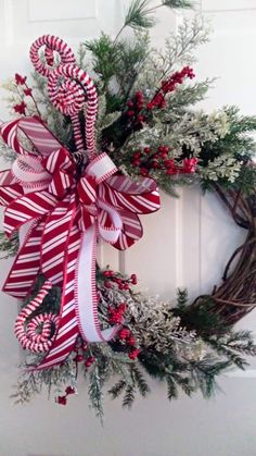 a christmas wreath with candy canes and greenery