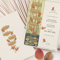 the wedding stationery is laid out on top of each other, with flowers and leaves