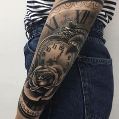 a woman's arm with a clock and rose tattoo on the left side of her arm