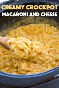 creamy crockpot mac and cheese in a slow cooker with a wooden spoon