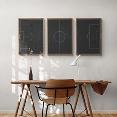 a wooden desk with two blackboards on the wall