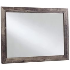 a wooden framed mirror on a white wall