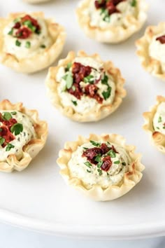 small appetizers are arranged on a white plate