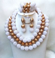 White with Gold Balls Wedding Bridal Party African Nigerian Beads Jewelry Set Complete Set is Necklace Earring and bracelet **Beads is acrylic  Wedding Party Bridal Special Occasion This detailed Jewellery set makes you stand out elegantly in any special occasion, it's all about glamour and uniqueness.  Buying more than 1 Jewellery set, we offer wholesale and bulk prices for all our jewellery. White Crystal Bridal Sets For Party, Bridal Necklace With Colorful Round Beads In White, White Bridal Necklace With Colorful Round Beads, Elegant White Bridal Sets For Party, White Beaded Necklace With Colorful Beads For Weddings, White Beaded Necklaces With Colorful Beads For Weddings, Pearl Beaded Necklace With Colorful Beads For Weddings, White Pearl Beaded Bracelet For Wedding, Wedding Pearl Beaded Necklaces With Colorful Beads