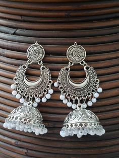 These are traditional pakistani/indian oxidized silver chand bali earings jhumka earrings  You will absolutely fall in love with this vintage inspired piece of jewelry. These earings can be used on any occasion or you can bring these earings in everyday use. At Nooritrendz we are striving to provide one on one communication and great customer service to all who wish to contact us. Customer's satisfaction is our priority.  You will get same product as we showcased in our listing.our high quality product will not leave you unsatisfied. Visit our shop and like 👍 💕 it to get regular updates https://www.etsy.com/ca/shop/nooritrendz Bohemian Silver Bridal Earrings With Latkans, Bohemian Bridal Earrings With Latkans In Silver, Bohemian Bridal Silver Earrings With Latkans, White Bohemian Earrings For Diwali, Bohemian White Earrings For Diwali, Bohemian Silver Round Bridal Earrings, Silver Bohemian Bridal Earrings, Bohemian Silver Bridal Earrings, Festive Silver Bohemian Hoop Earrings