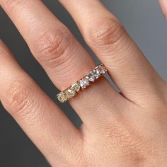 a woman's hand with a yellow and white diamond ring