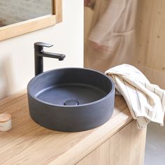 a bathroom sink sitting on top of a wooden counter