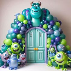 some balloons and monsters in front of a door