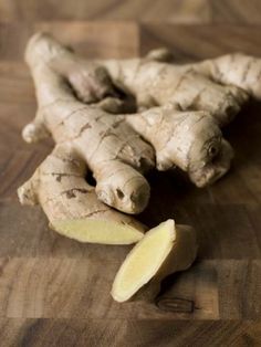 a close up of a sliced ginger on a wooden surface