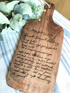 a wooden cutting board with writing on it