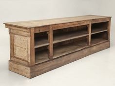 an old wooden entertainment center with drawers and shelves on the bottom, against a white background