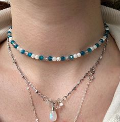 This beautiful beaded choker is handmade by me from start to finish, and is the perfect accessory for the summer! I used genuine blue apatite, mother of pearl, and labradorite beads to create this piece. This choker was originally made to be 15". If you would like an extender added, please choose the 18" variation. If you are interested in a longer extender or larger size, please message me! I always try to accommodate different sizes.   I love creating these necklaces, and I am always happy to consider custom orders! I can personalize by color, size/texture of the beads, and add your favorite crystals! Prizes or customs are subject to change based on cost of materials and time spent creating the piece. Dainty Handmade Round Bead Choker, Bohemian Choker With Faceted Beads For Festivals, Trendy Handmade Turquoise Beaded Necklaces, Bohemian Faceted Beads Choker For Festivals, Dainty Handmade Beaded Choker Necklace, Handmade Dainty Crystal Choker Necklace, Handmade Crystal Choker Necklace For Festival, Trendy Handmade Beaded Choker Necklace, Festival Gemstone Beads Choker Necklace