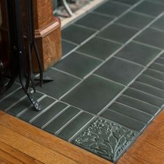 a close up of a tile floor near a fire place