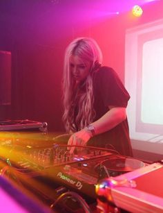 a woman in black shirt djing at a party