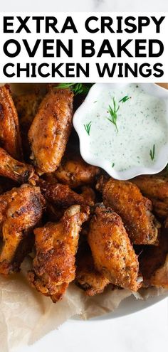 chicken wings with ranch dressing on the side and text overlay that reads extra crispy oven baked chicken wings