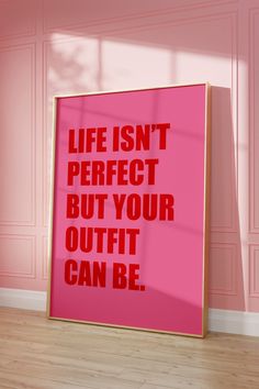 a pink poster with the words life isn't perfect but your outfit can be