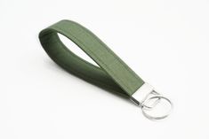 a keychain with a metal ring on it's end and a green lanyard