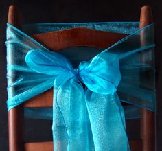 a chair with a blue bow tied to it