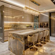 an elegant kitchen with marble counter tops and bar stools