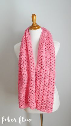 a pink crocheted scarf on top of a mannequin