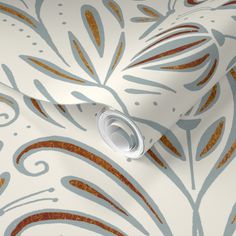 a white and gold wallpaper with an intricate design on it's side, next to a roll of toilet paper