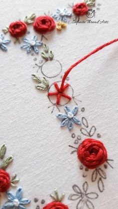 an embroidered card with red and blue flowers on it