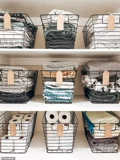 the shelves are filled with folded towels and other items in baskets on top of them