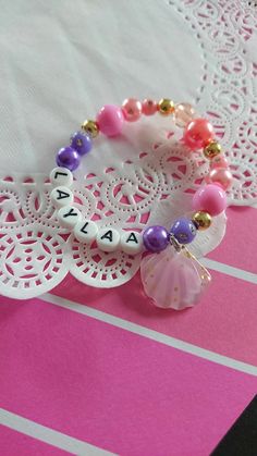 Shell Name bracelet, Mermaid jewelry, Mermaid bracelet, name jewelry, birthday favor, birthday bracelet, mermaid birthday, mermaid party.******************Give something magical to the magical girl in your life.DETAILS and MEASUREMENT:Plastic beads.6.5"You may also check our facebook page for previous orders we have done.www.facebook.com/buysomeloveIf you stumbled on this bracelet through this listing, please don't forget to visit the rest of our shop at:www.buysomelove.ca Themed Pink Bracelets For Birthday, Customized Themed Bracelets For Birthday, Pink Themed Birthday Bracelets, Themed Personalized Beaded Bracelets For Birthday, Personalized Themed Beaded Bracelets For Birthday, Personalized Themed Adjustable Name Bracelet, Pink Birthday Bracelet With Lobster Clasp, Bracelet Name, Birthday Mermaid