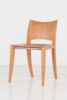 a wooden chair sitting on top of a white floor