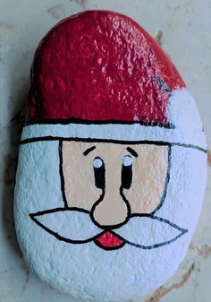 a painted rock with a santa claus face on it and the words kindness rocks by mrappallo