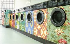 a row of multicolored washers sitting next to each other in a room