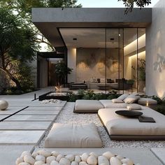 an outdoor living area with large rocks and plants