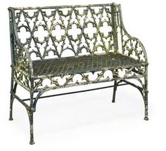 an ornate iron bench is shown against a white background