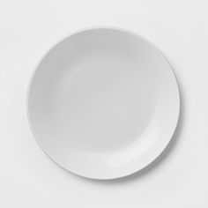 an empty white plate on a white surface