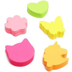 four pieces of paper with different shapes and colors on white background, including pink, yellow, green, and orange