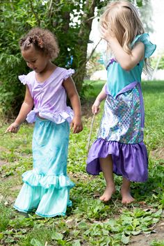 Let your little one splash into a new adventure in their new Purple Sparkle Mermaid dress up! Bodice made of a soft knit that has a shimmery foil print and china silk sleeves Embellished with a heat seal purple starfish and matching trim Fin is made up of a plethora of colors that glimmer and shine as the light hits them to give it that realistic scale feeling Breathable, Silky Soft, 100% Polyester Fabrics Accessories Sold Separately Fitted Purple Dress For Playwear, Purple Mermaid Dress For Dress-up, Fitted Mermaid Dress For Summer Dress-up, Purple Mermaid Dress For Summer, Summer Purple Mermaid Dress With Mermaid Hem, Purple Summer Mermaid Dress, Summer Purple Mermaid Dress, Purple Starfish, Purple Sparkle