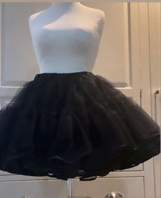 Handmade, made to order, black dress net vintage style,circle skirt style.Available in UK clothing size. Small 10-12, medium 12-14, large 16-18, and X-Large size 20-22.The length is above- the-knee. The waistband has an elastic inside. washable with matching delicate colours. The length is 40cm(16")with 3 layers of dress net,each consisting of 2 tiers,and a soft polyester material underskirt. Edged in a delicate black bias trim.Ideal for the festive season too! Ideal present for your wife, girlf Party Skirt With Can-can Crinoline, Black Ruffled Tulle Petticoat, Black Fitted Petticoat For Party, Black Crinoline Full Skirt Petticoat, Black Full Skirt Crinoline Petticoat, Vintage Party Petticoat With Ruffled Skirt, Black Tiered Skirt Petticoat For Wedding, Black Ruffled Full Skirt Petticoat, Black Full Skirt Petticoat For Wedding