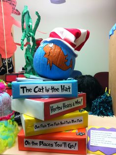 the cat in the hat is sitting on top of some books