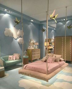 a bedroom with blue walls and pink bedding