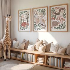 a giraffe is standing in front of some bookshelves with pillows on them