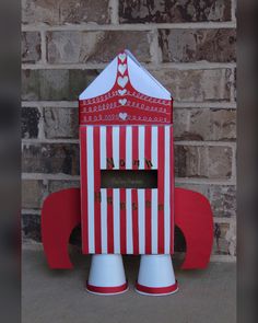 a red and white striped box shaped like a rocket ship